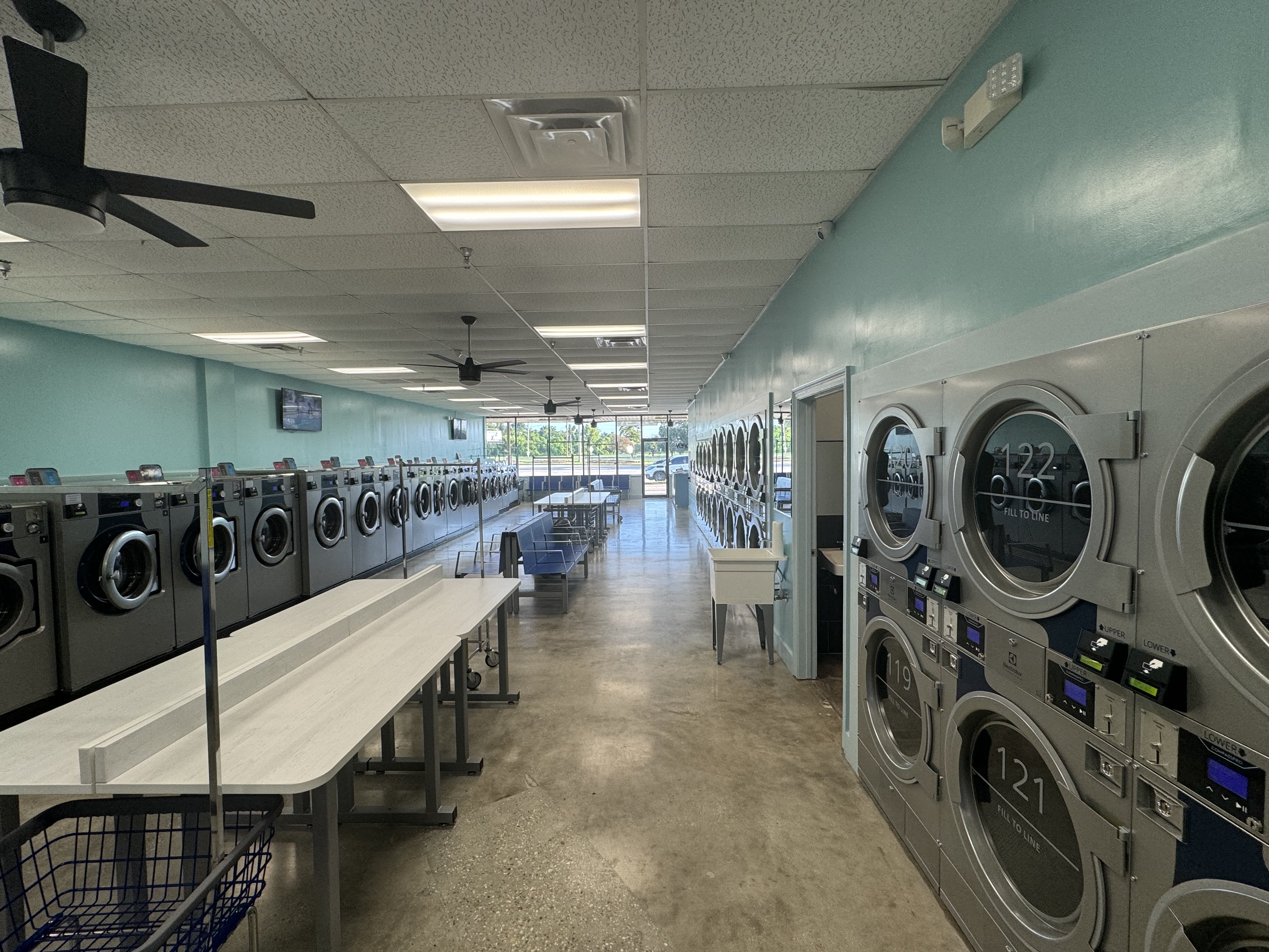Bright Suds N Tubs laundromat interior with rows of washers and dryers